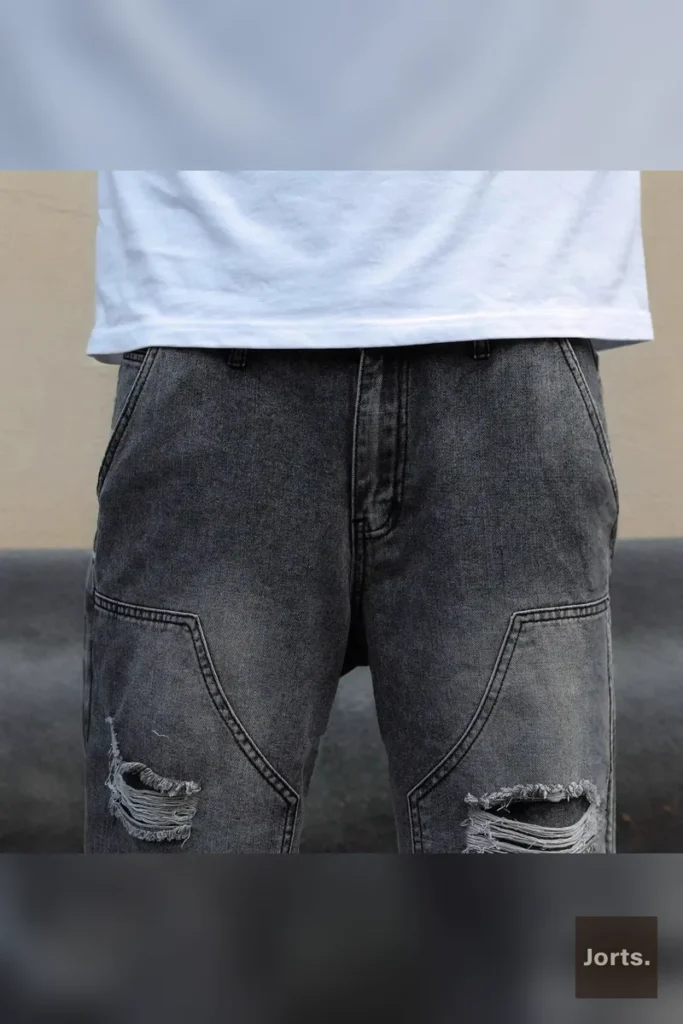 Side profile of men's gray straight-leg denim shorts, emphasising the cropped length and fit.