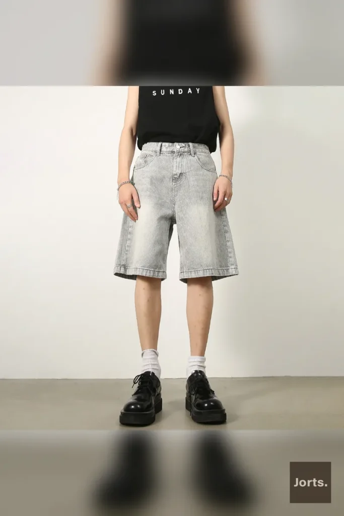 Close-up detail of the pocket on men's retro washed denim jorts, showing fabric texture.