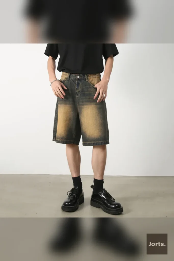 Male model wearing gray retro washed loose fit jorts in a casual Y2K streetwear outfit.